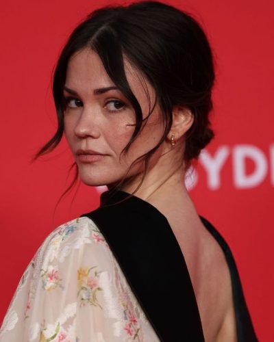 Maia Mitchell loose waves hairstyle complementing floral gown