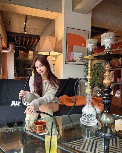 Makoto Minami styled in oversized sweater and tailored shorts ensemble.