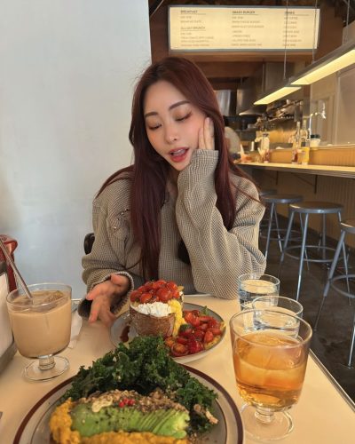 Makoto Minami warm taupe sweater and tailored shorts.