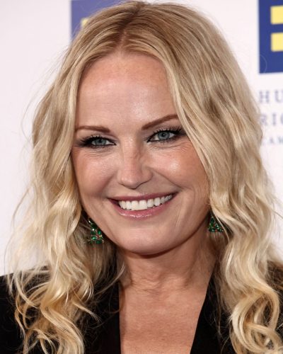 Malin Akerman emerald statement earrings complementing her hairstyle