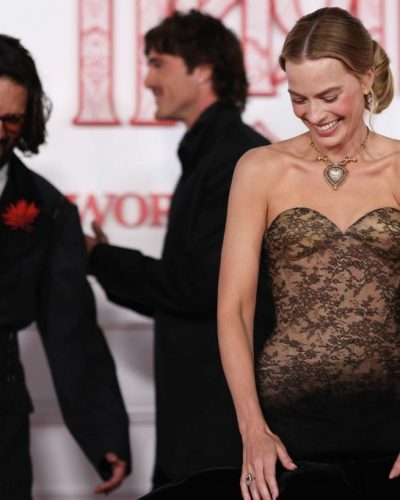 Margot Robbie dressed in a casual floral dress with a soft vibe.