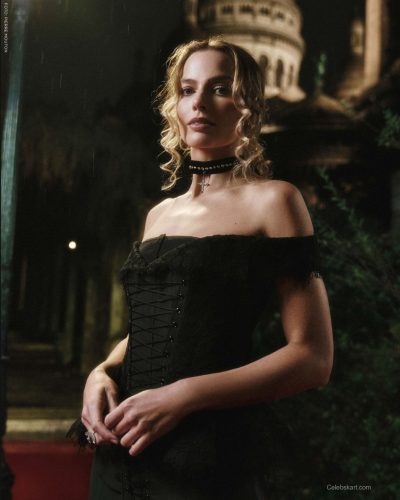 Margot Robbie styled in a floral maxi dress with a vibrant print.