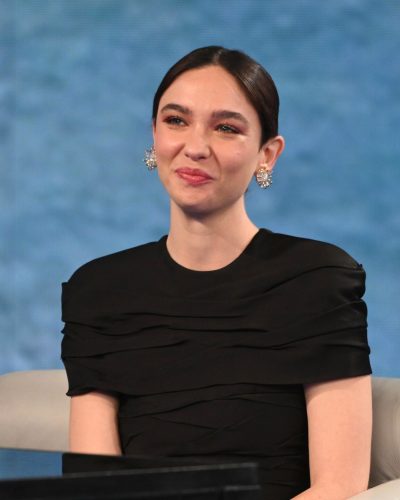 Matilda De Angelis black dress with ruffled detailing and dark heels