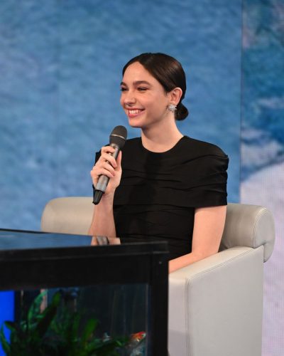 Matilda De Angelis sophisticated black dress with ruffles and sleek heels