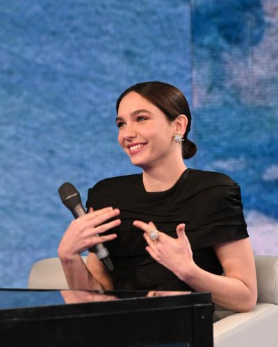 Matilda De Angelis black gown with subtle ruffles and sophisticated heels