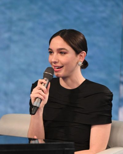 Matilda De Angelis sleek black gown with delicate ruffles and heels