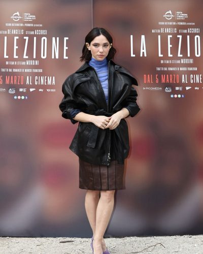 Matilda De Angelis trendy blue turtleneck under black leather jacket