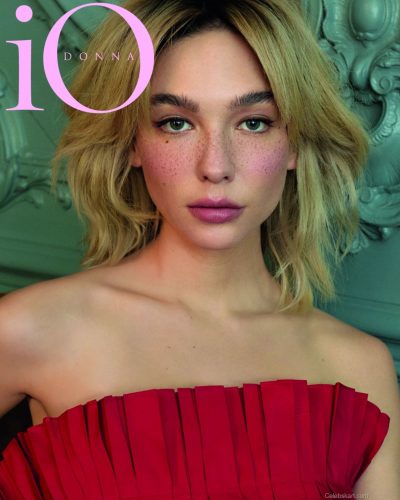 Matilda De Angelis in bold red strapless gown with intricate folds.