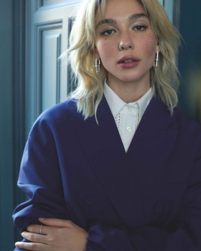 Matilda De Angelis in bright red gown with textured detailing.