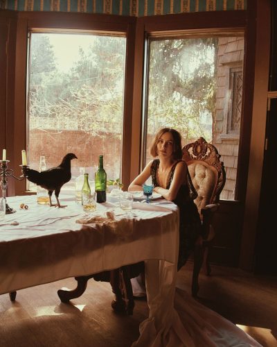 Maude Apatow featuring a tailored black jacket and elegant black dress.