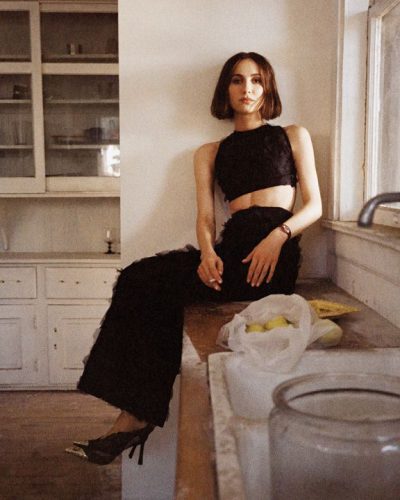 Maude Apatow wearing a daring black dress with intricate accessories.