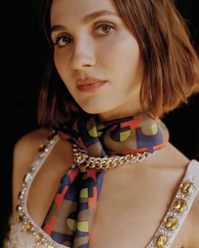 Maude Apatow wearing a structured black jacket with a layered dress.