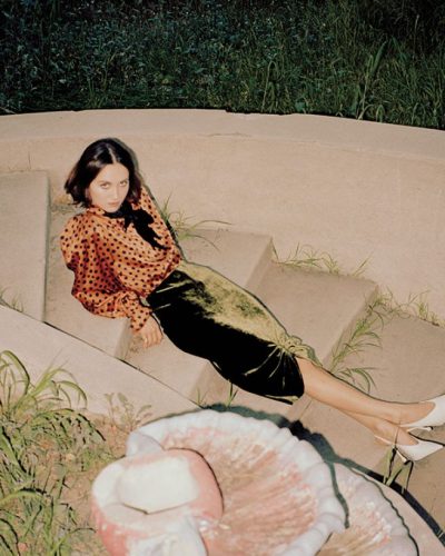 Maude Apatow in a chic black dress complemented by bold accessories.