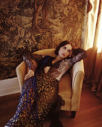 Maude Apatow in a tailored black jacket and sleek black dress.