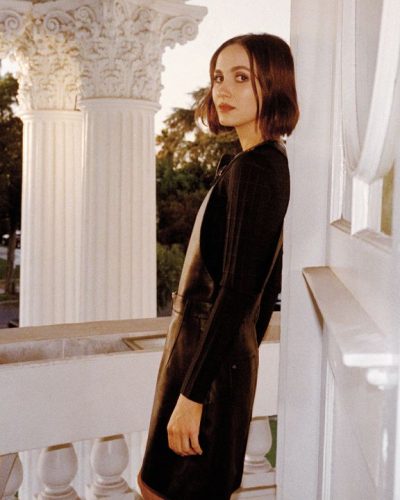 Maude Apatow with a delicate flower necklace and black ensemble.