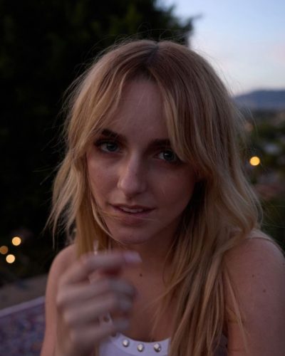 Mckenna Grace wearing a playful skirt with large flower accent