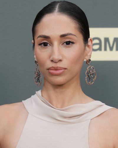 Meaghan Rath hair slicked back, statement earrings