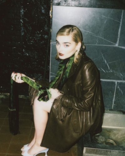 Meg Donnelly midriff-baring leather top, voluminous beige trousers