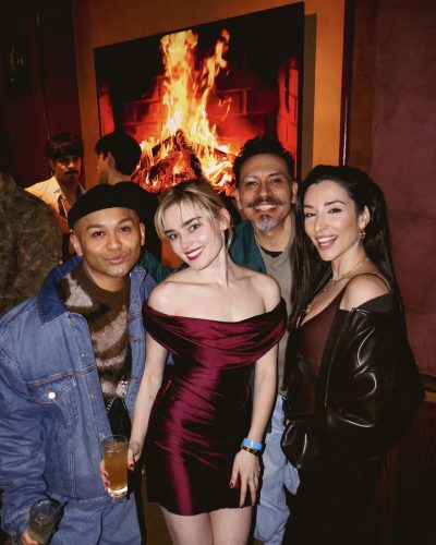 Meg Donnelly dressed in a striking deep red satin dress.