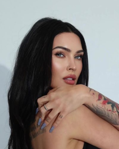 Megan Fox in gray pleated skirt with black bikini top