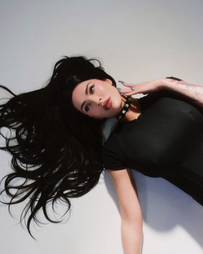 Megan Fox in black high-waisted bottoms paired with fitted top