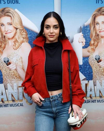 Melissa Barrera wearing a black top and light-wash denim