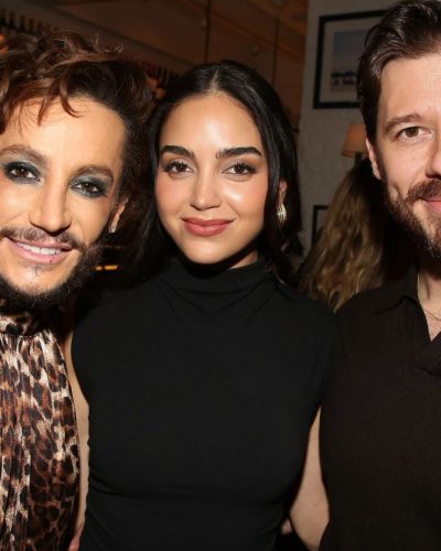 Melissa Barrera styled in a red jacket and fitted black top