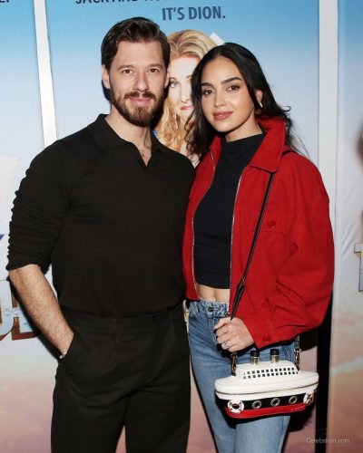 Melissa Barrera with light-wash jeans and chic white handbag