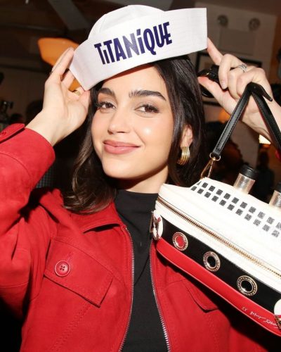 Melissa Barrera with a fitted black top and stylish jeans