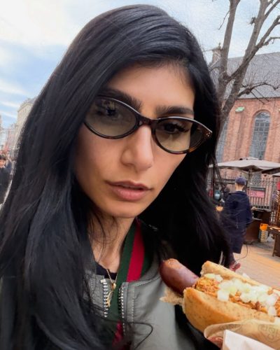 Mia Khalifa in fitted black top and flared pants.