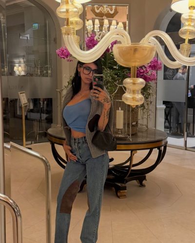 Mia Khalifa wearing relaxed black top with stylish flared pants.