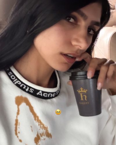 Mia Khalifa dressed in fitted top and black flared pants.