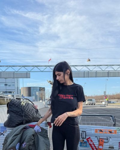 Mia Khalifa in casual black flared pants and fitted top.