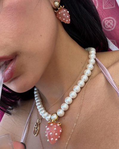 Mia Khalifa in pink bikini with matching pearl necklace