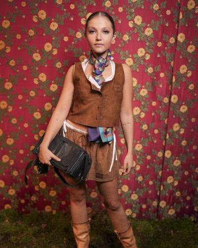 Mia McKenna-Bruce wearing matching brown skirt and vest