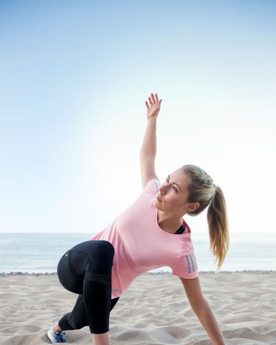 Mikaela Shiffrin in light pink workout shirt and black leggings.