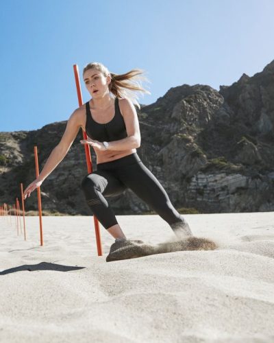 Mikaela Shiffrin wearing red sports bra with matching high-waisted leggings.