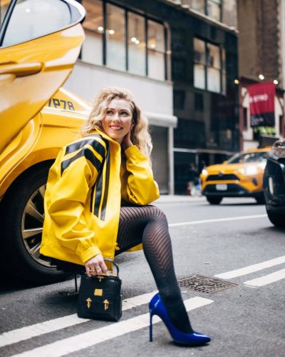Mikaela Shiffrin wearing yellow jacket against NYC backdrop