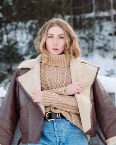 Mikaela Shiffrin winter beige sweater with relaxed denim jeans