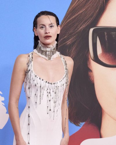 Milena Smit in a striking white dress featuring delicate chains