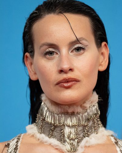 Milena Smit wearing a soft sheen white dress with metallic elements