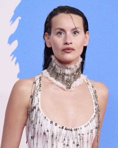 Milena Smit wearing a chic white dress with elegant chains