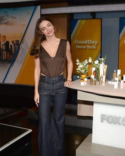 Miranda Kerr with fitted brown top and elegant flared jeans