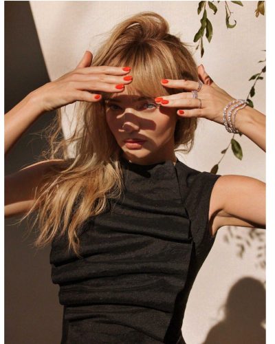 Miranda Kerr in light-colored dress with layered floral design