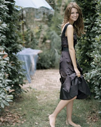 Mischa Barton in a red dress complemented by natural surroundings