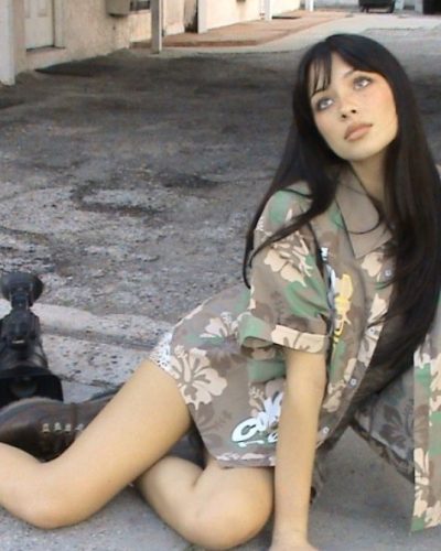 Mishka Silva in light-hued jumpsuit with deep neckline