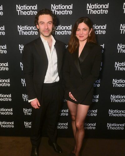 Monica Barbaro wearing a sleek black blazer with sharp tailoring.