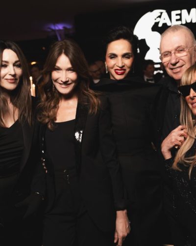 Monica Bellucci wearing a black dress with delicate draping.