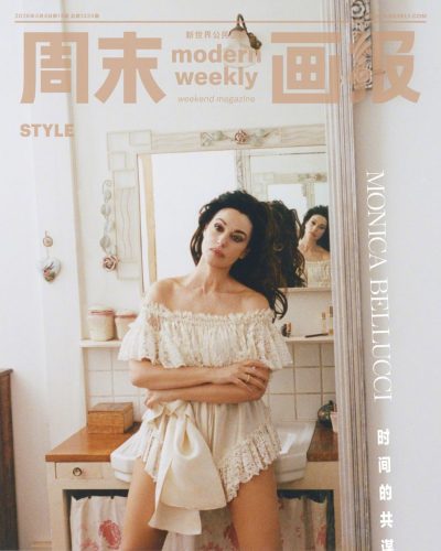 Monica Bellucci in a stylish beige dress with dramatic sleeves.