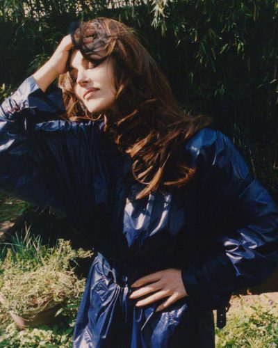 Monica Bellucci in a sophisticated beige dress with puffy details.